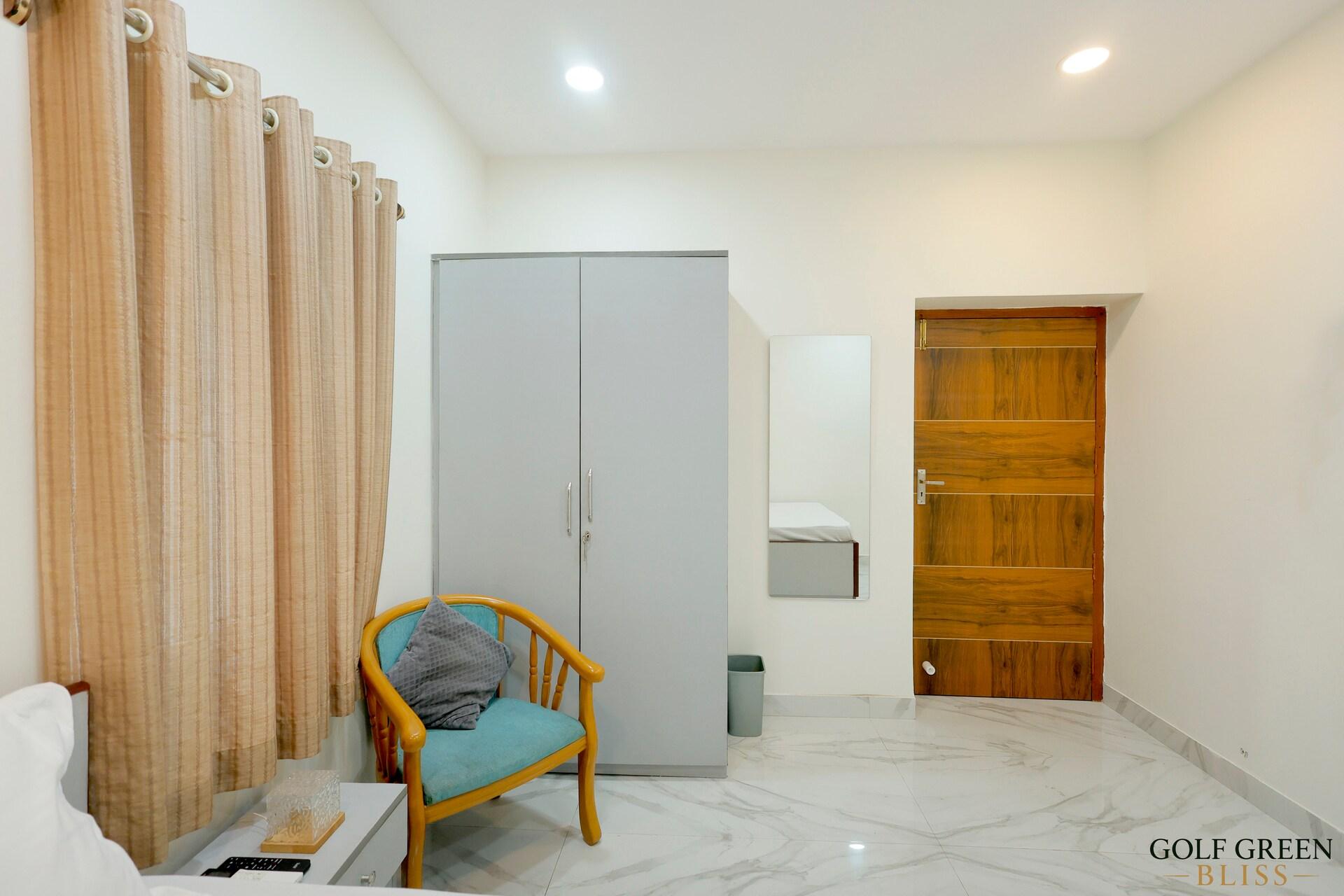 Bedroom one looking towards the wardrobe and the polished wooden door