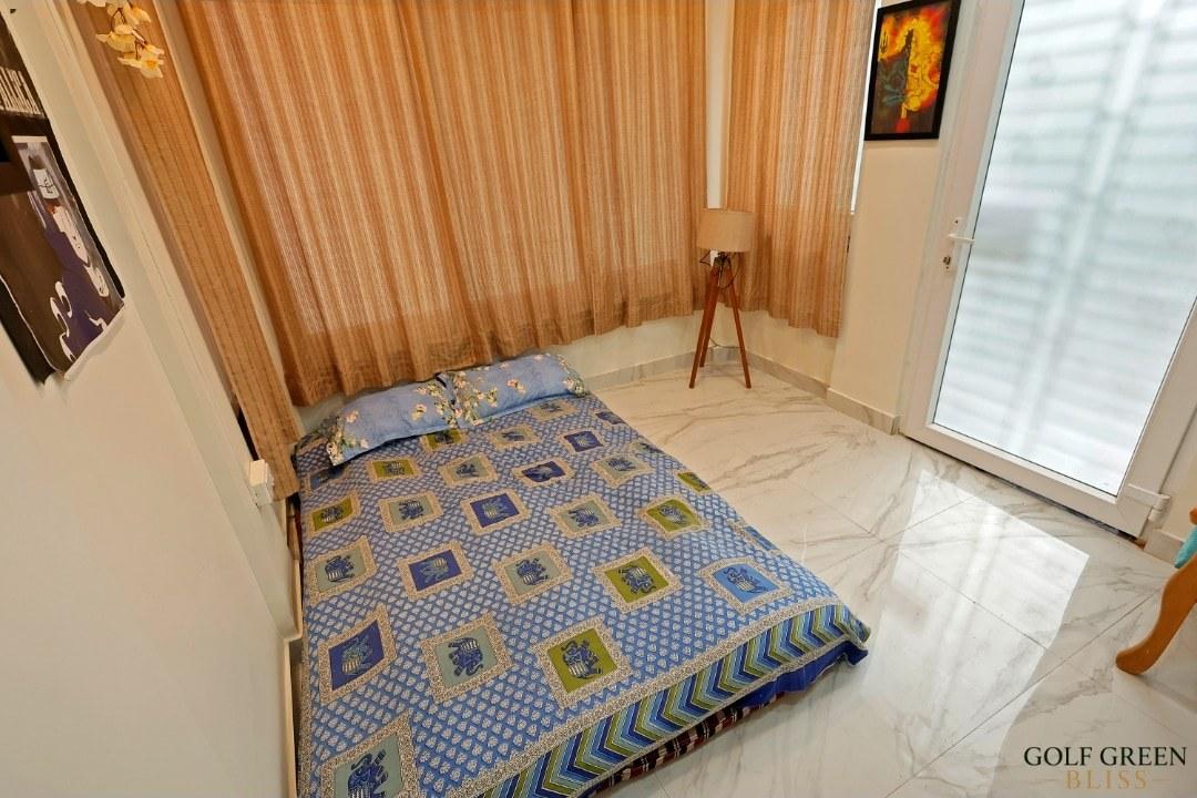 Bedroom three's floor mattress with block-print bedding, seen from the doorway